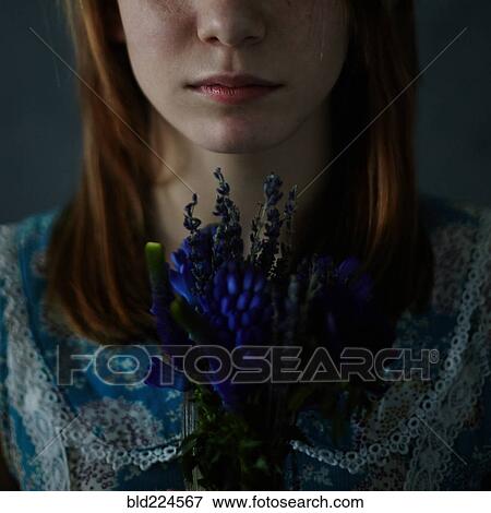 Stock Photo - Caucasian teenage girl holding bouquet of flowers. Fotosearch