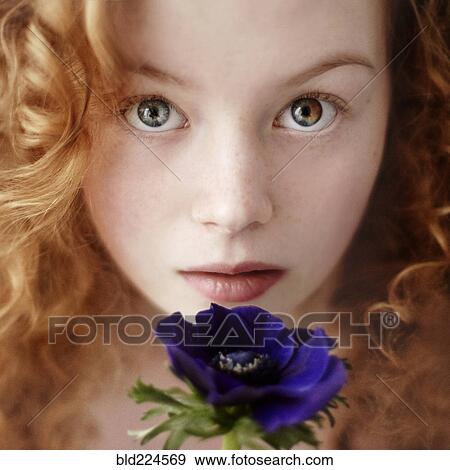 Caucasian teenage girl holding flower View Large Photo Image Stock Photo - Caucasian teenage girl holding flower. Fotosearch