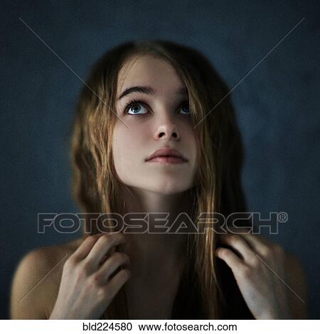 Stock Image - Caucasian teenage girl looking up. Fotosearch