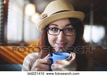Stock Image - Caucasian woman drinking coffee. Fotosearch