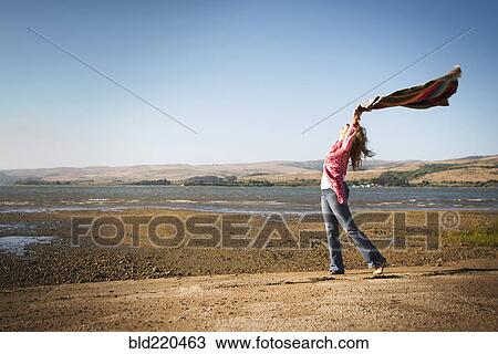 Caucasian woman holding blanket in wind View Large Photo Image Stock Image - Caucasian woman holding blanket in wind. Fotosearch