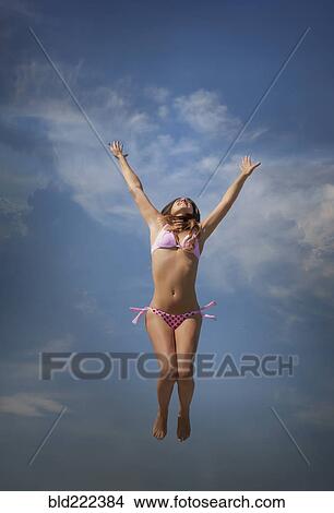 Caucasian woman in bikini jumping for joy View Large Photo Image Picture - Caucasian woman in bikini jumping for joy. Fotosearch