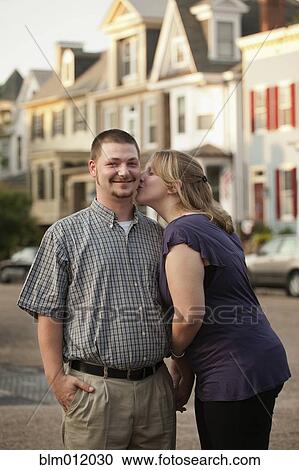 Caucasian woman kissing husband View Large Photo Image Stock Image - Caucasian woman kissing husband. Fotosearch