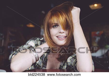 Stock Photo - Caucasian woman leaning on table. Fotosearch