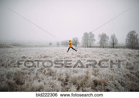 Caucasian woman leaping in snowy field View Large Photo Image Stock Photograph - Caucasian woman leaping in snowy field. Fotosearch
