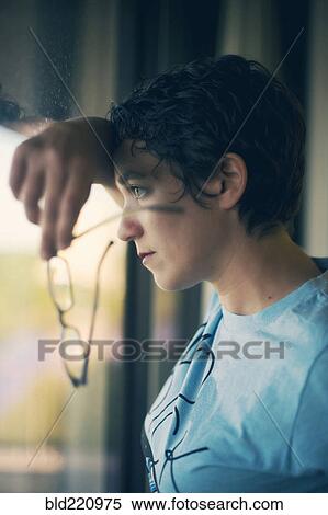 Stock Photography - Caucasian woman looking out window. Fotosearch