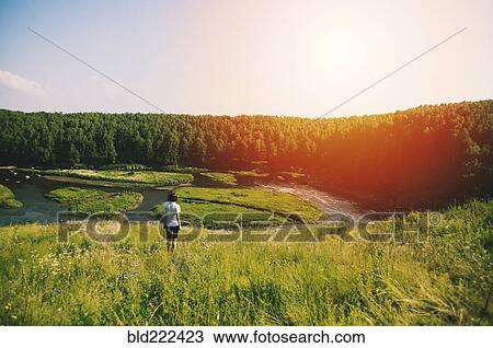 Caucasian woman on hill over remote river View Large Photo Image Stock Image - Caucasian woman on hill over remote river. Fotosearch