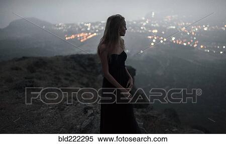 Caucasian woman on hilltop admiring cityscape view View Large Photo Image Stock Photography - Caucasian woman on hilltop admiring cityscape view. Fotosearch