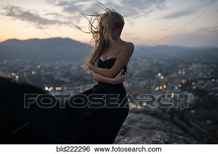 Caucasian woman on hilltop near cityscape view View Large Photo Image Stock Photograph - Caucasian woman on hilltop near cityscape view. Fotosearch