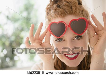 Caucasian woman peeking from heart-shape sunglasses View Large Photo Image Stock Photography - Caucasian woman peeking from heart-shape sunglasses. Fotosearch