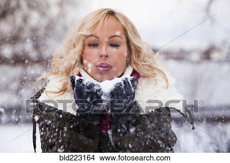 Picture - Caucasian woman playing in snow. Fotosearch