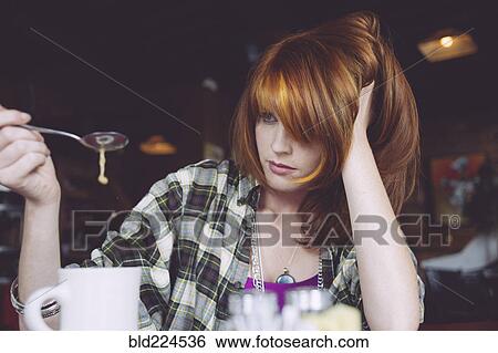 Caucasian woman playing with coffee in cafe View Large Photo Image Stock Photograph - Caucasian woman playing with coffee in cafe. Fotosearch