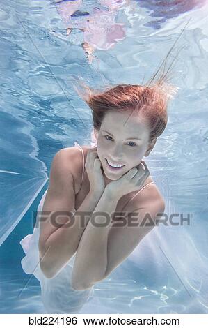 Stock Photograph - Caucasian woman posing in pool. Fotosearch