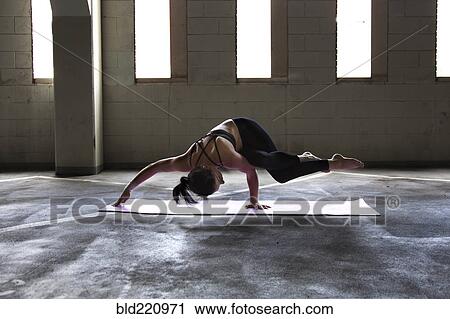 Caucasian woman practicing yoga in parking lot View Large Photo Image Stock Image - Caucasian woman practicing yoga in parking lot. Fotosearch