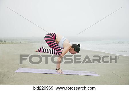 Caucasian woman practicing yoga on beach View Large Photo Image Stock Photo - Caucasian woman practicing yoga on beach. Fotosearch
