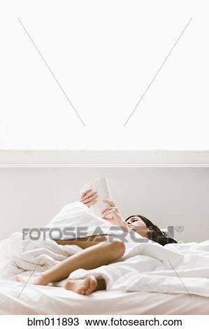 Caucasian woman reading book in bed View Large Photo Image Stock Image - Caucasian woman reading book in bed. Fotosearch