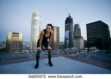 Caucasian woman resting on urban rooftop View Large Photo Image Stock Image - Caucasian woman resting on urban rooftop. Fotosearch