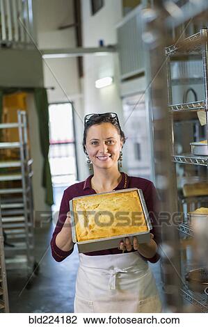 Caucasian woman showing cake in bakery pan View Large Photo Image Stock Image - Caucasian woman showing cake in bakery pan . Fotosearch