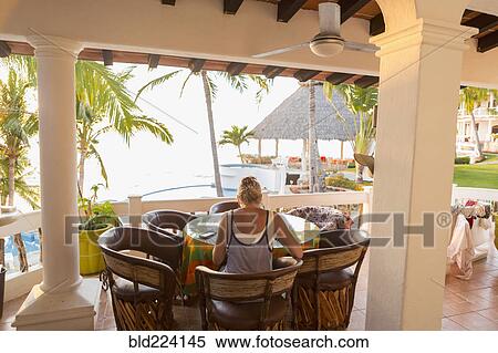 Caucasian woman sitting at waterfront table View Large Photo Image Stock Photography - Caucasian woman sitting at waterfront table. Fotosearch