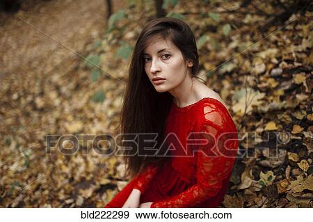 Caucasian woman sitting in autumn leaves View Large Photo Image Stock Photo - Caucasian woman sitting in autumn leaves. Fotosearch