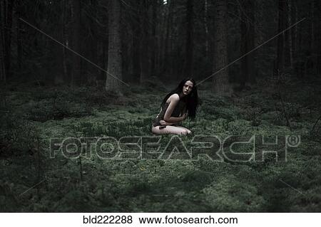 Caucasian woman sitting in forest View Large Photo Image Stock Photo - Caucasian woman sitting in forest. Fotosearch