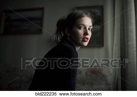 Stock Photography - Caucasian woman sitting in living room. Fotosearch