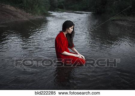 Caucasian woman sitting in remote stream View Large Photo Image Stock Photography - Caucasian woman sitting in remote stream. Fotosearch