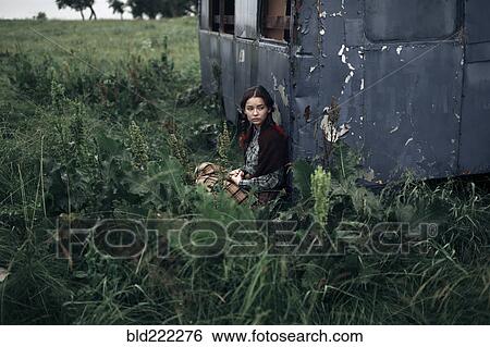 Caucasian woman sitting near remote field View Large Photo Image Stock Photograph - Caucasian woman sitting near remote field. Fotosearch