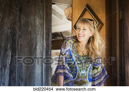 Picture - Caucasian woman smiling in doorway. Fotosearch