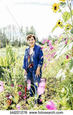 Stock Photo - Caucasian woman smiling in garden. Fotosearch