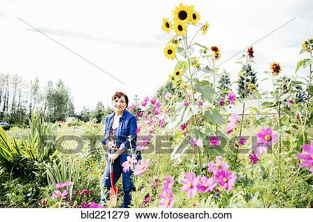 Stock Photo - Caucasian woman smiling in garden. Fotosearch