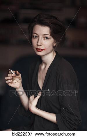 Caucasian woman smoking indoors View Large Photo Image Stock Photo - Caucasian woman smoking indoors. Fotosearch