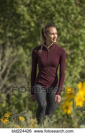 Caucasian woman standing in flowers View Large Photo Image Stock Photograph - Caucasian woman standing in flowers. Fotosearch