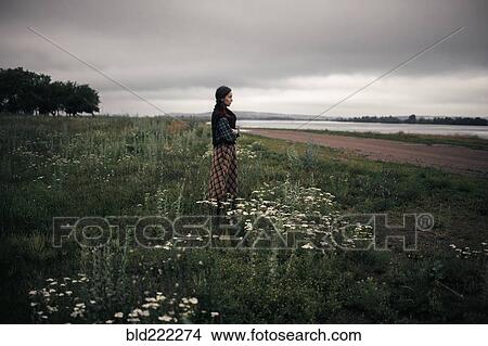 Caucasian woman standing in remote field View Large Photo Image Picture - Caucasian woman standing in remote field. Fotosearch