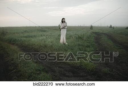 Caucasian woman standing in remote field View Large Photo Image Stock Image - Caucasian woman standing in remote field. Fotosearch