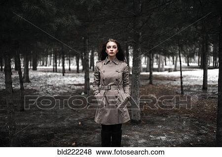 Caucasian woman standing in snowy forest View Large Photo Image Stock Photo - Caucasian woman standing in snowy forest. Fotosearch