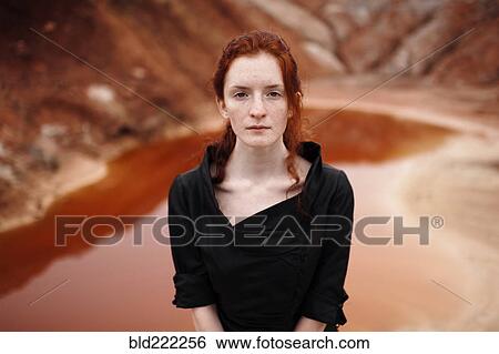 Stock Photograph - Caucasian woman standing near remote pool. Fotosearch