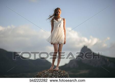 Caucasian woman standing on remote hilltop View Large Photo Image Stock Image - Caucasian woman standing on remote hilltop. Fotosearch