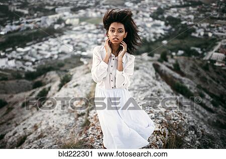 Caucasian woman standing on remote hilltop View Large Photo Image Stock Image - Caucasian woman standing on remote hilltop. Fotosearch