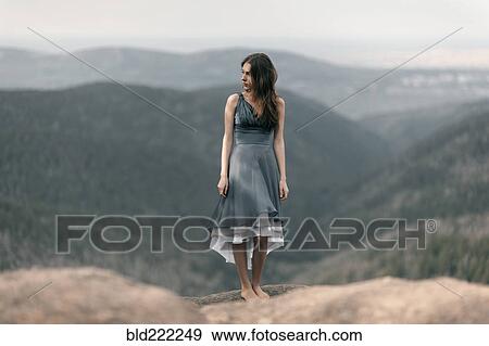 Caucasian woman standing on remote mountaintop View Large Photo Image Stock Photo - Caucasian woman standing on remote mountaintop. Fotosearch