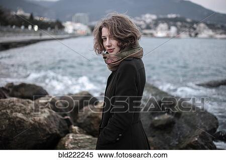 Caucasian woman standing on rock formation in harbor View Large Photo Image Stock Photography - Caucasian woman standing on rock formation in harbor. Fotosearch