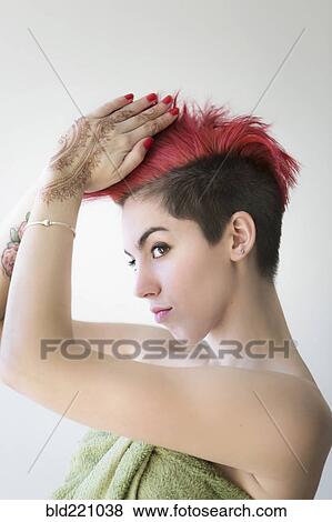 Stock Photo - Caucasian woman styling dyed hair. Fotosearch