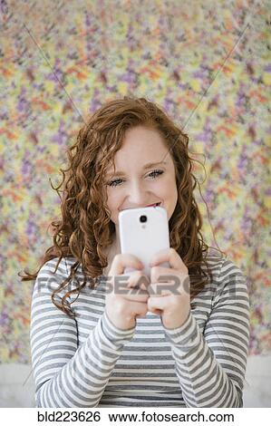 Caucasian woman taking cell phone selfie View Large Photo Image Stock Photograph - Caucasian woman taking cell phone selfie. Fotosearch