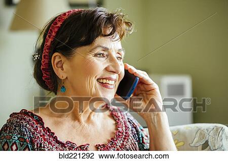 Stock Image - Caucasian woman talking on cell phone. Fotosearch
