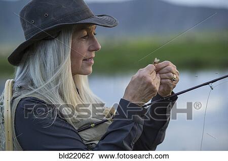 Caucasian woman tying fishing line in remote lake View Large Photo Image Stock Photo - Caucasian woman tying fishing line in remote lake. Fotosearch