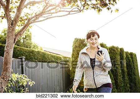 Caucasian woman using cell phone outdoors View Large Photo Image Stock Image - Caucasian woman using cell phone outdoors. Fotosearch
