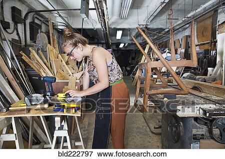 Caucasian woman using digital tablet in workshop View Large Photo Image Stock Photo - Caucasian woman using digital tablet in workshop. Fotosearch