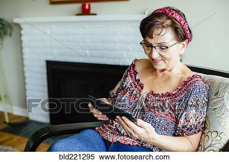 Stock Photography - Caucasian woman using digital tablet. Fotosearch