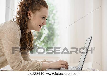 Caucasian woman using laptop View Large Photo Image Stock Image - Caucasian woman using laptop. Fotosearch