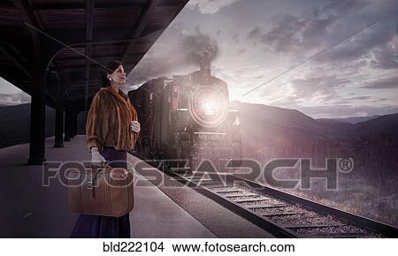 Picture - Caucasian woman waiting in train station. Fotosearch